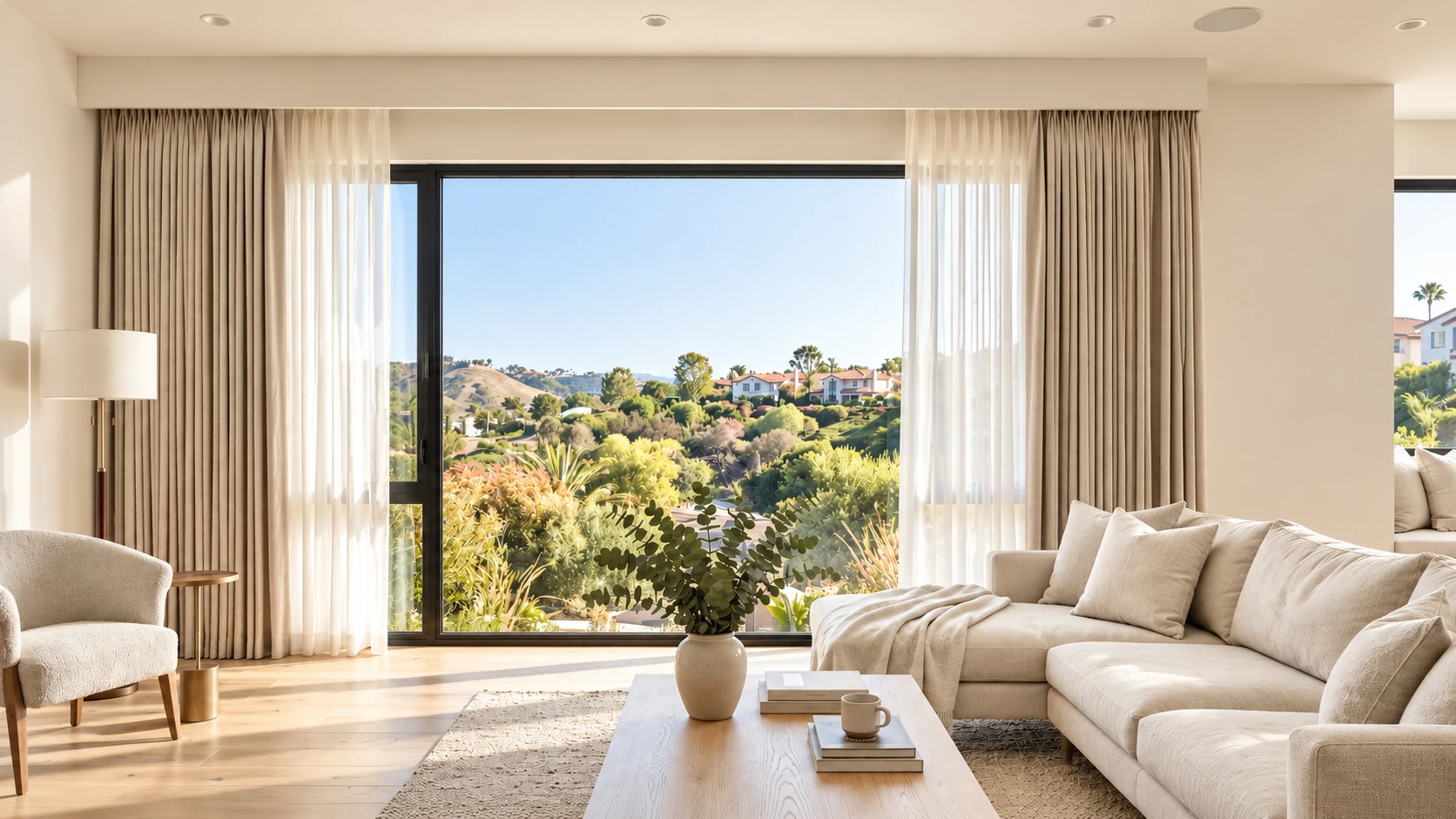 Layered curtains fully open beneath a concealed curtain box in a sunlit living room